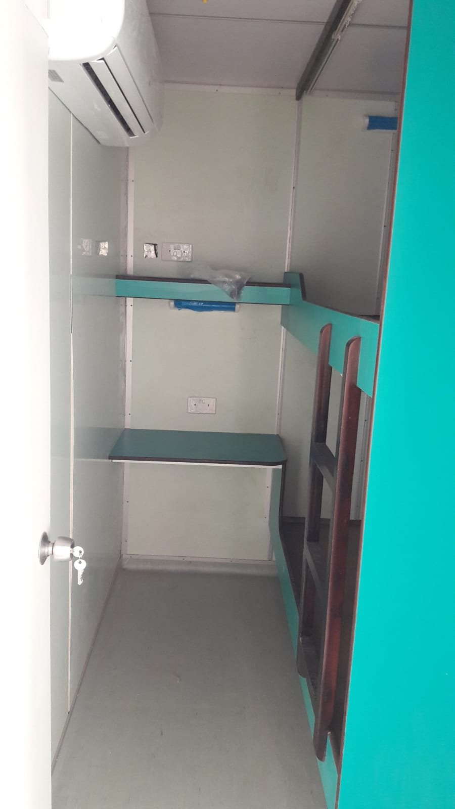 Accommodation cabin interior with bunk beds and storage shelf