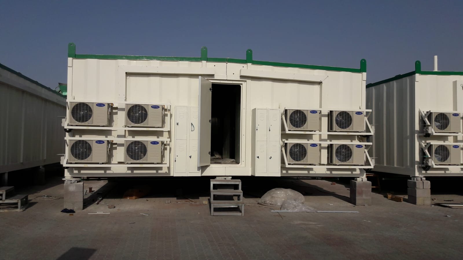 Row of cabin units with split AC units and access steps